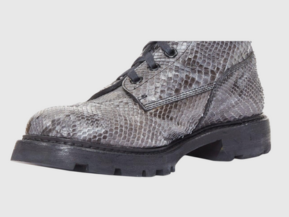Close-up of men's python leather boot and lug sole