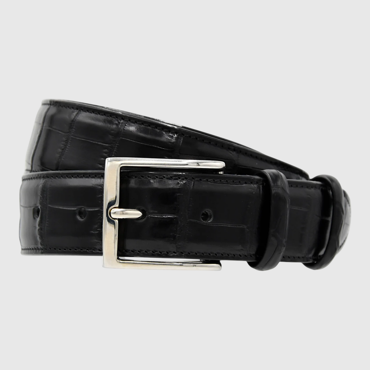 Close-up of genuine black crocodile leather belt craftsmanship