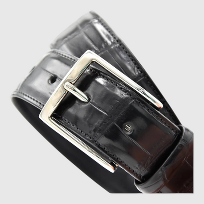 Close-up of men's genuine black crocodile leather belt buckle
