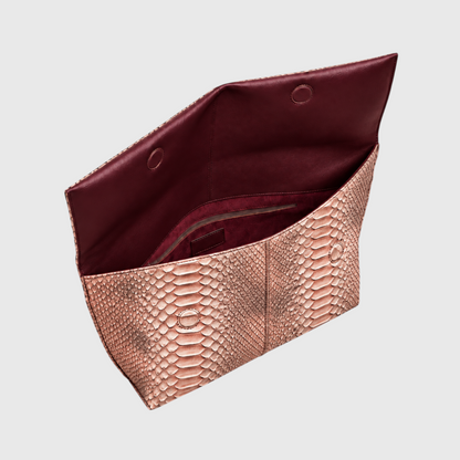 Copper rose python leather foldover clutch open showing burgundy interior and zip pocket