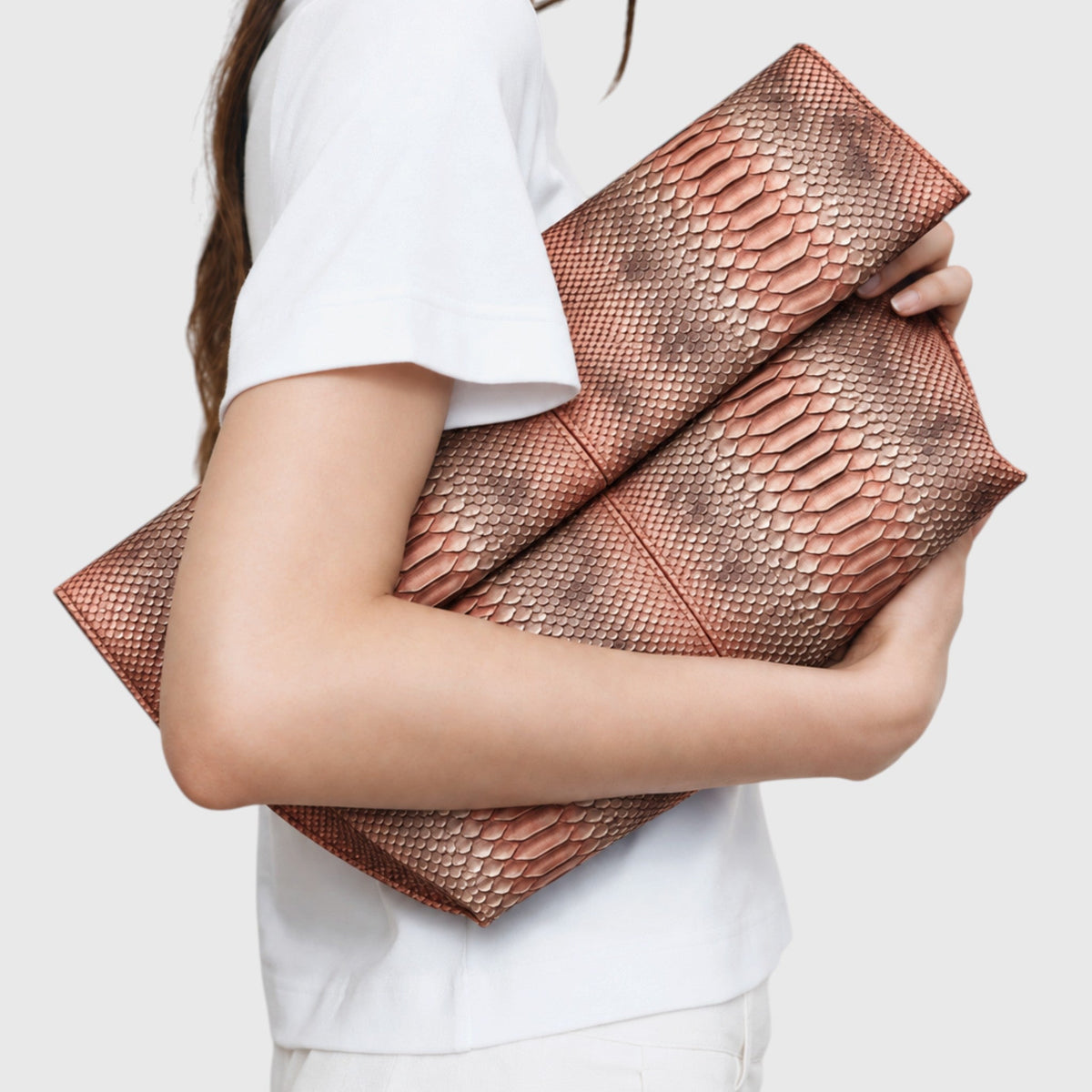 Copper rose genuine python leather clutch styled under the arm