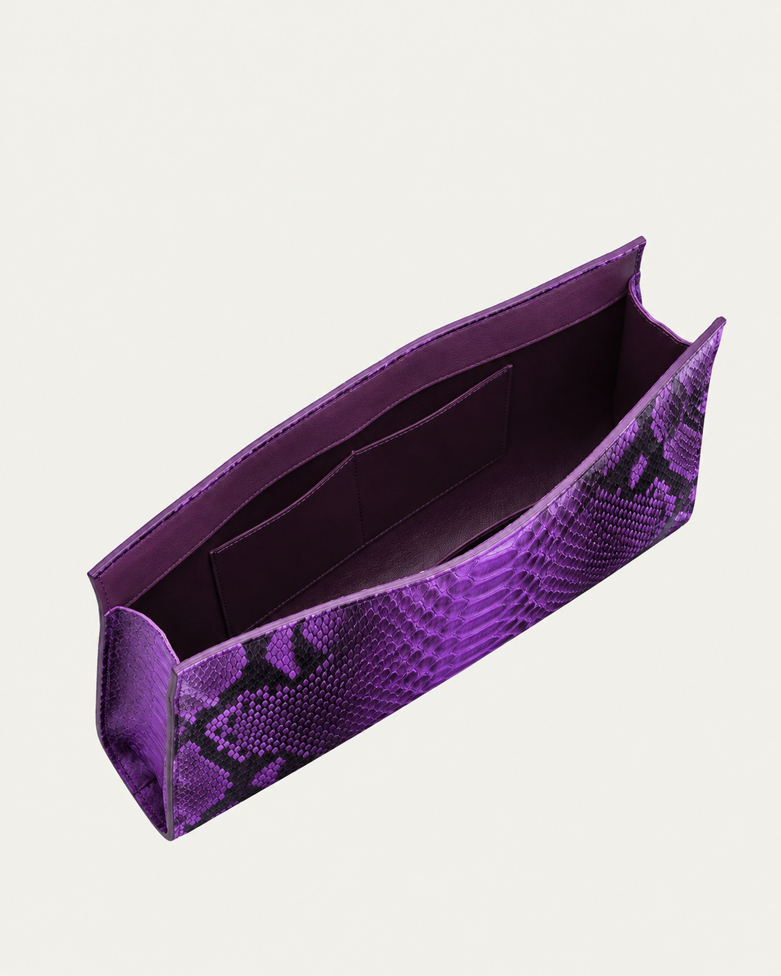 Purple python leather clutch open showing dark purple lining and internal pocket