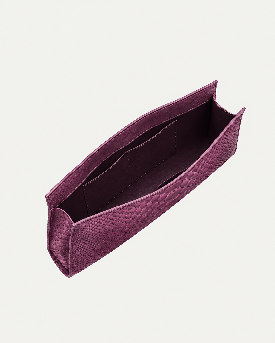 Smoky Plum python leather clutch showing deep plum interior and pocket