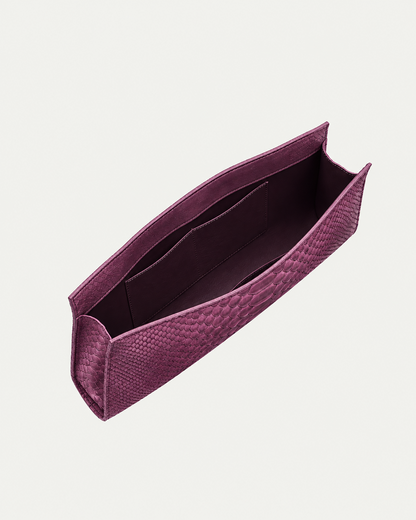 Smoky Plum python leather clutch showing deep plum interior and pocket