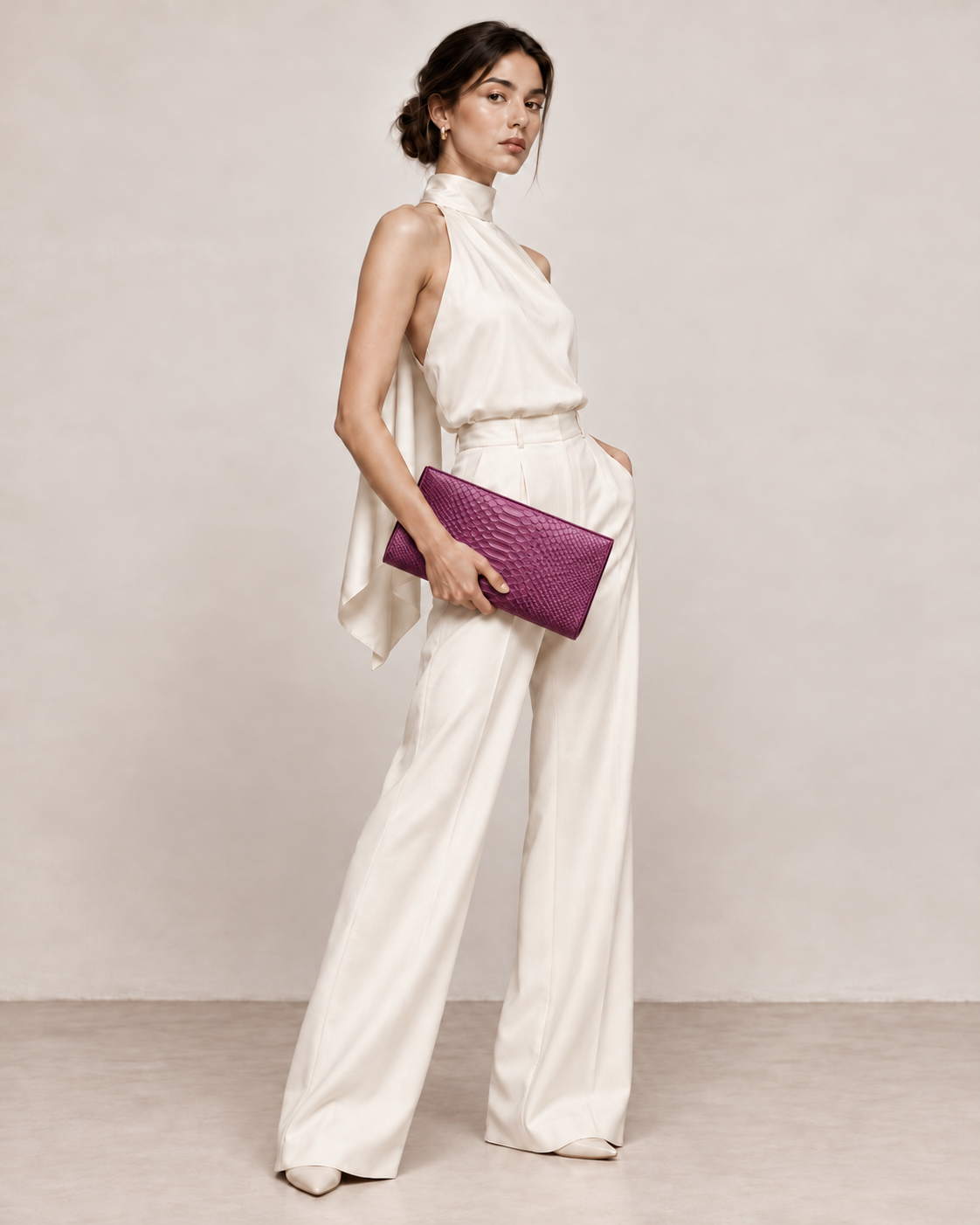 Elegant model in ivory carrying Smoky Plum python clutch