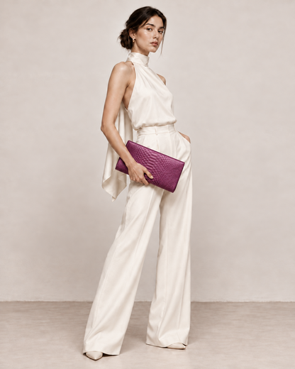 Elegant model in ivory carrying Smoky Plum python clutch