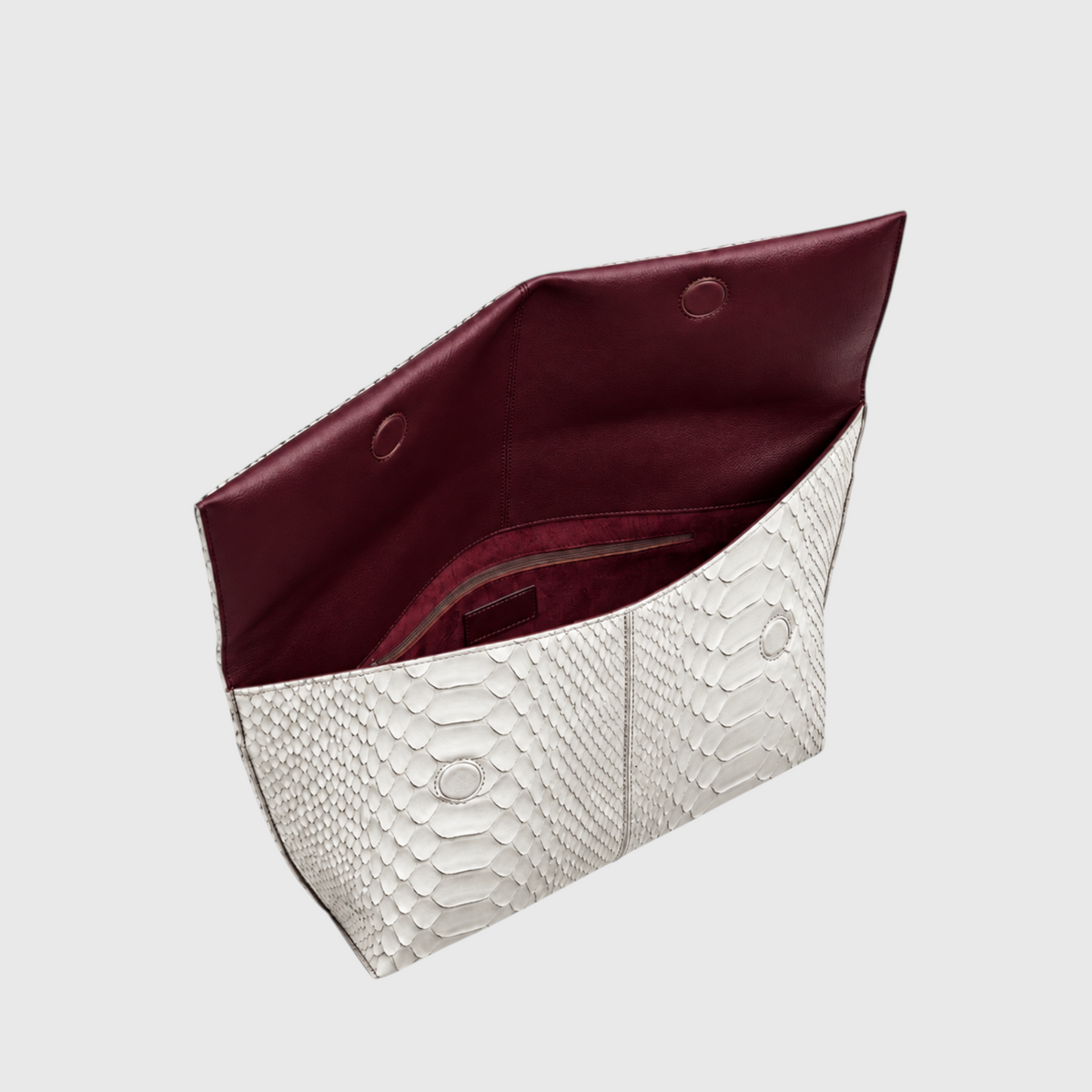 Ivory genuine python leather clutch opened, showing burgundy interior, magnets and zip pocket