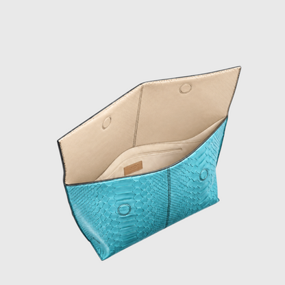 Turquoise python leather clutch open, showing beige lining, magnetic flap closure and interior zip pocket