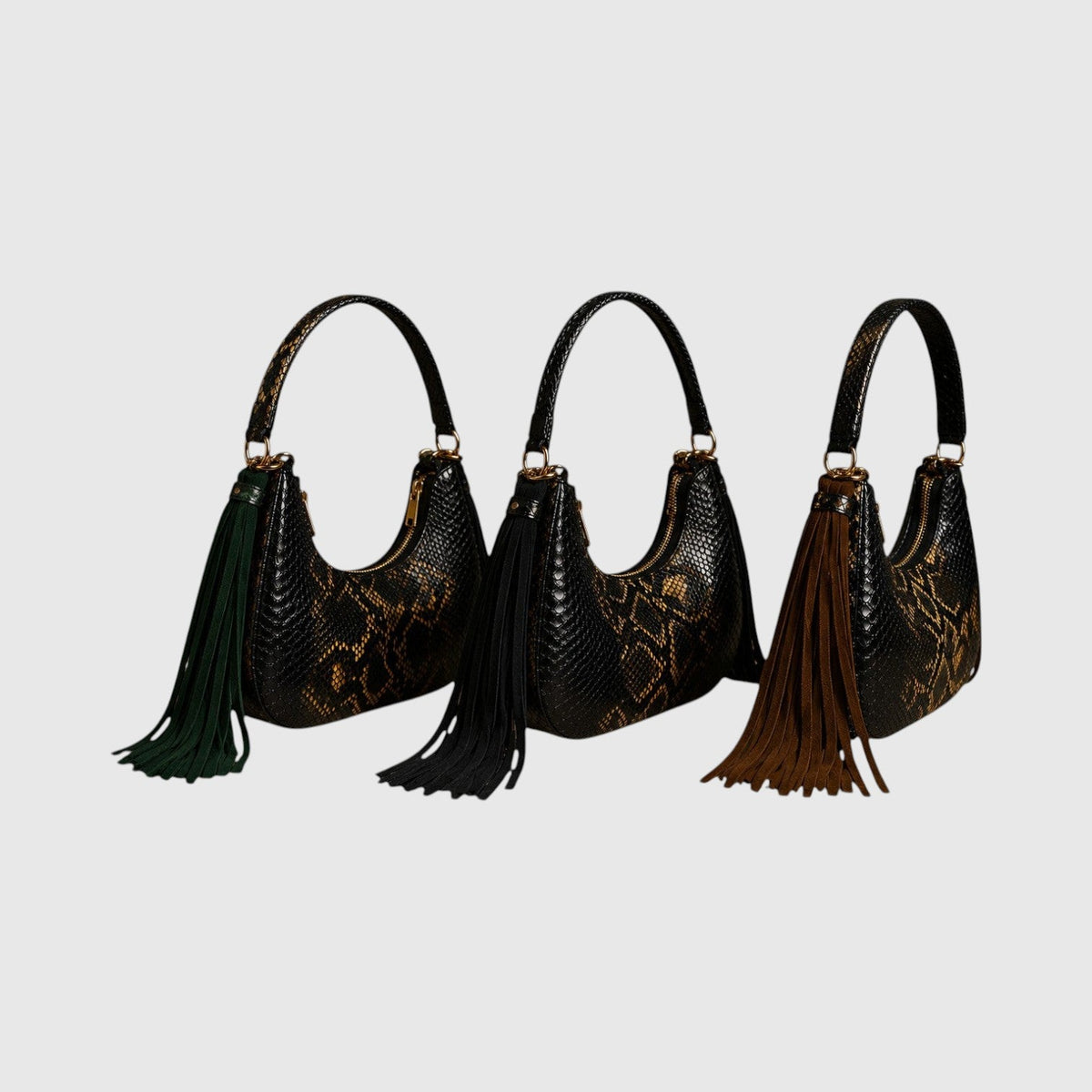 Trois sacs hobo Fofana Bag Leather craftman en cuir de python véritable avec pompons en daim colorés et détails dorés.