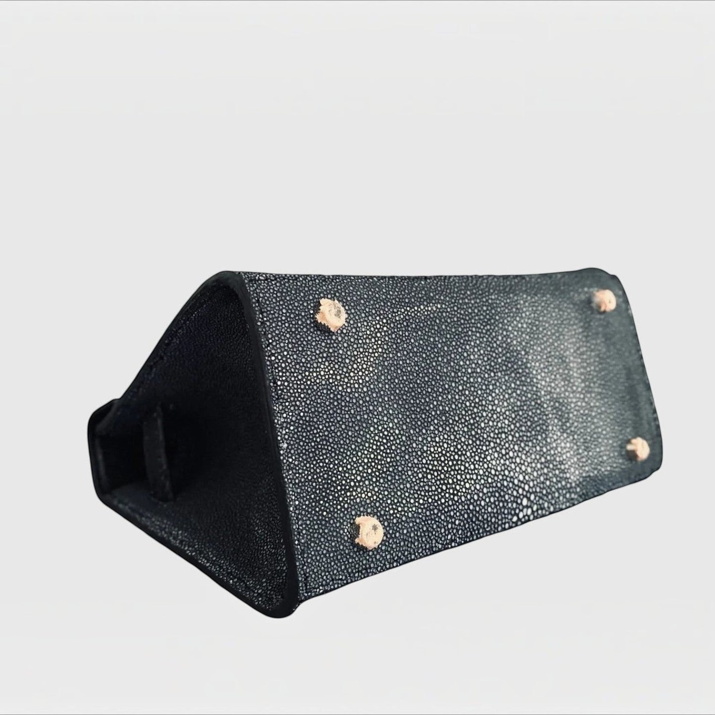 Base du sac à main structuré Leather craftman en cuir de galuchat noir avec quatre pieds métalliques de protection