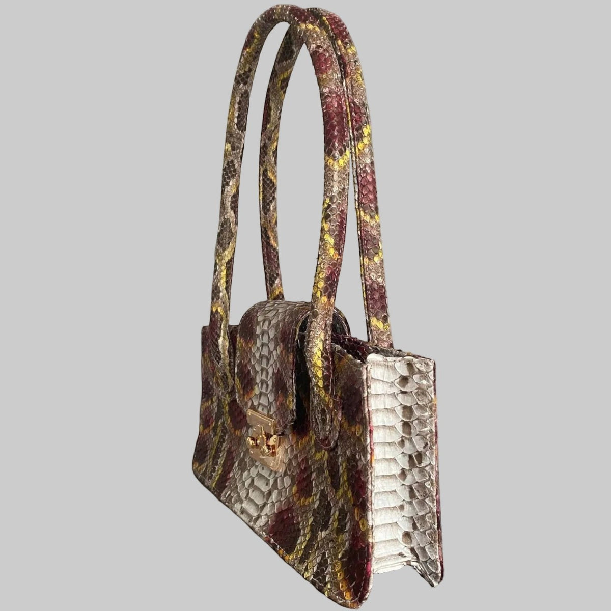 Sac à main Leather craftman Serpentina Rubis en cuir de python véritable multicolore avec fermoir doré.