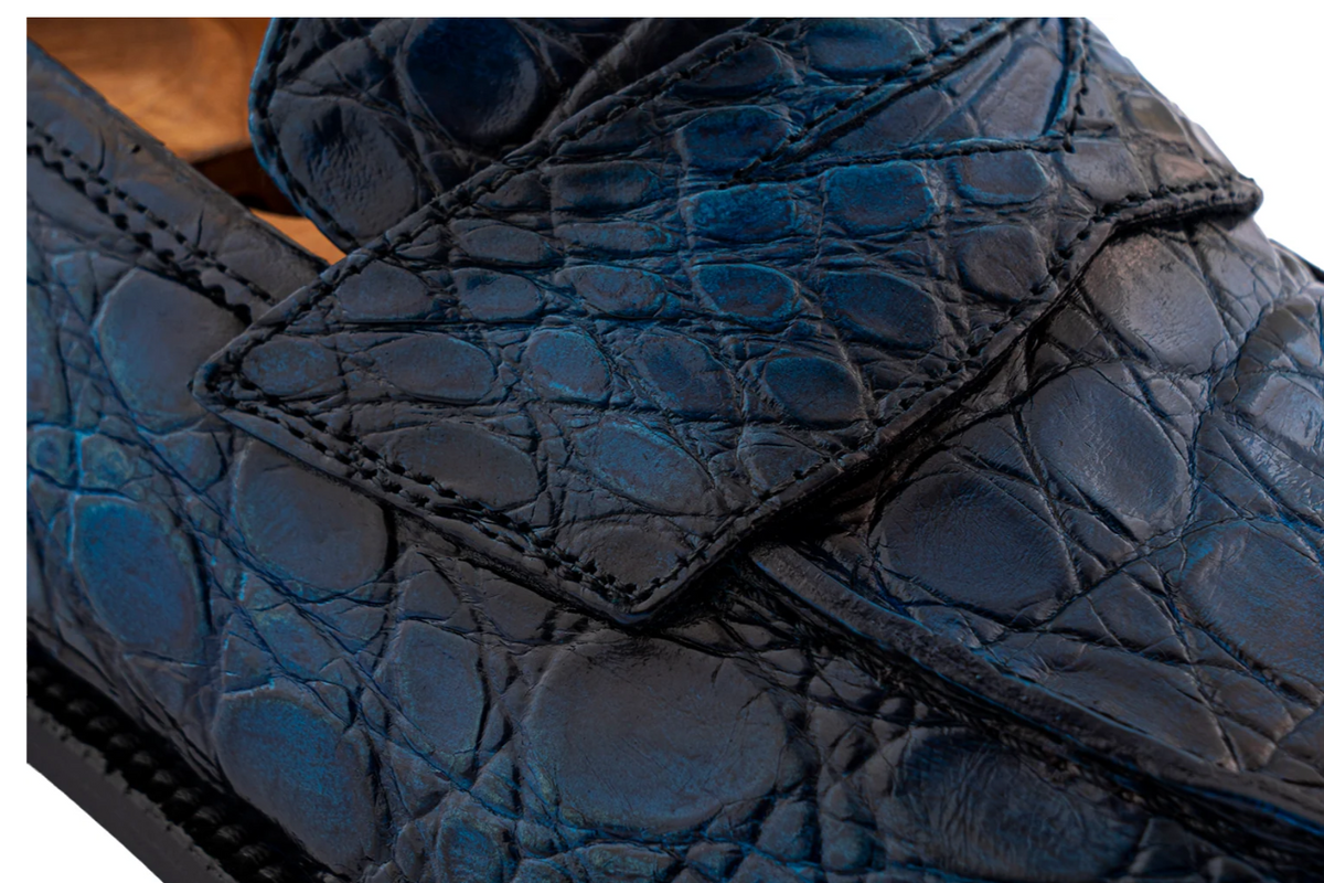 Close-up of hand-painted genuine crocodile leather on men's loafers in blue